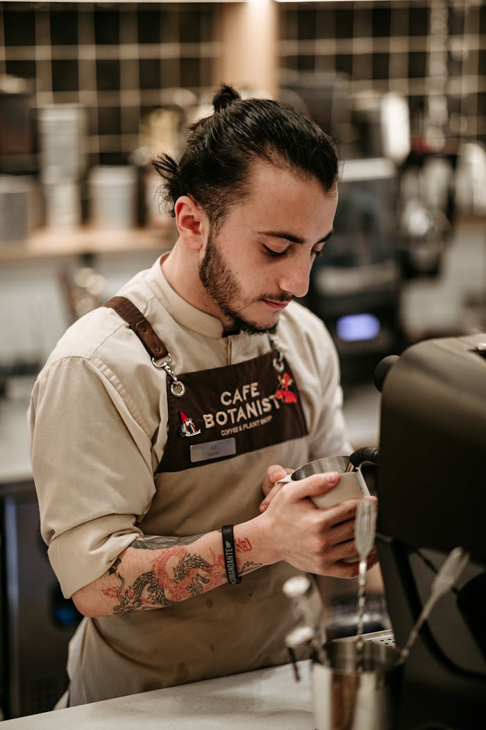 Barista preparing coffee with skill and focus at a trendy café location.