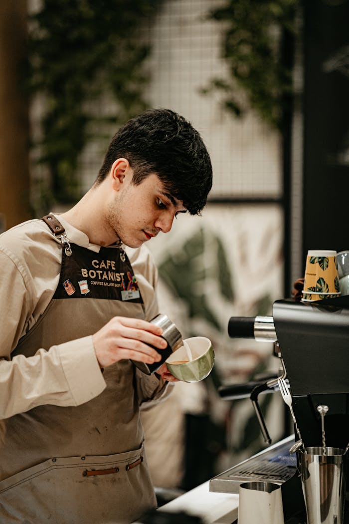 A skilled barista prepares coffee at a modern cafe, showcasing professional brewing techniques.