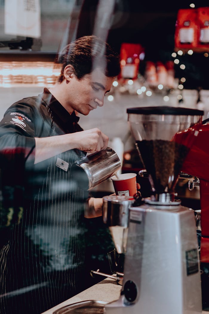 Café scene with a barista pouring coffee in a stylish coffee shop in Baku, Azerbaijan.